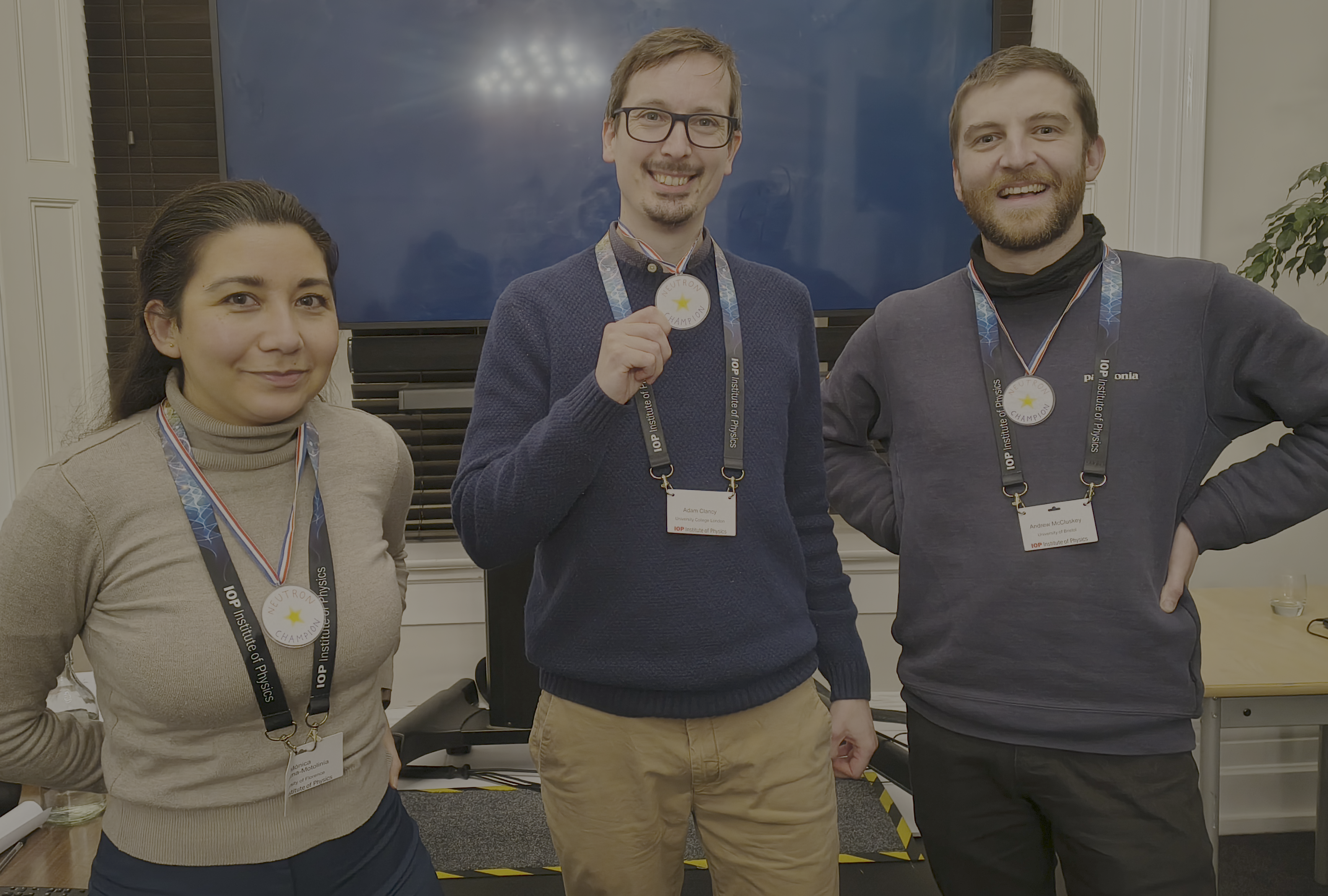Mónica Ledesma-Motolinía, Adam Clancy, and Andrew with their "Neutron Champion" medals